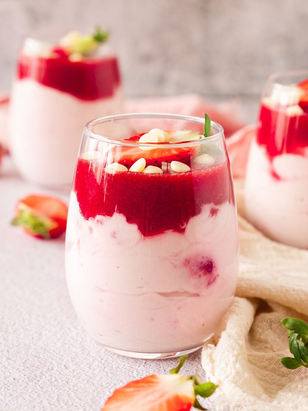 Three glasses filled with strawberry mousse.