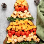 Christmas tree cheese board with tomatoes and rosemary.