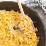 Cast iron skillet with corn cooked with cream cheese and honey.
