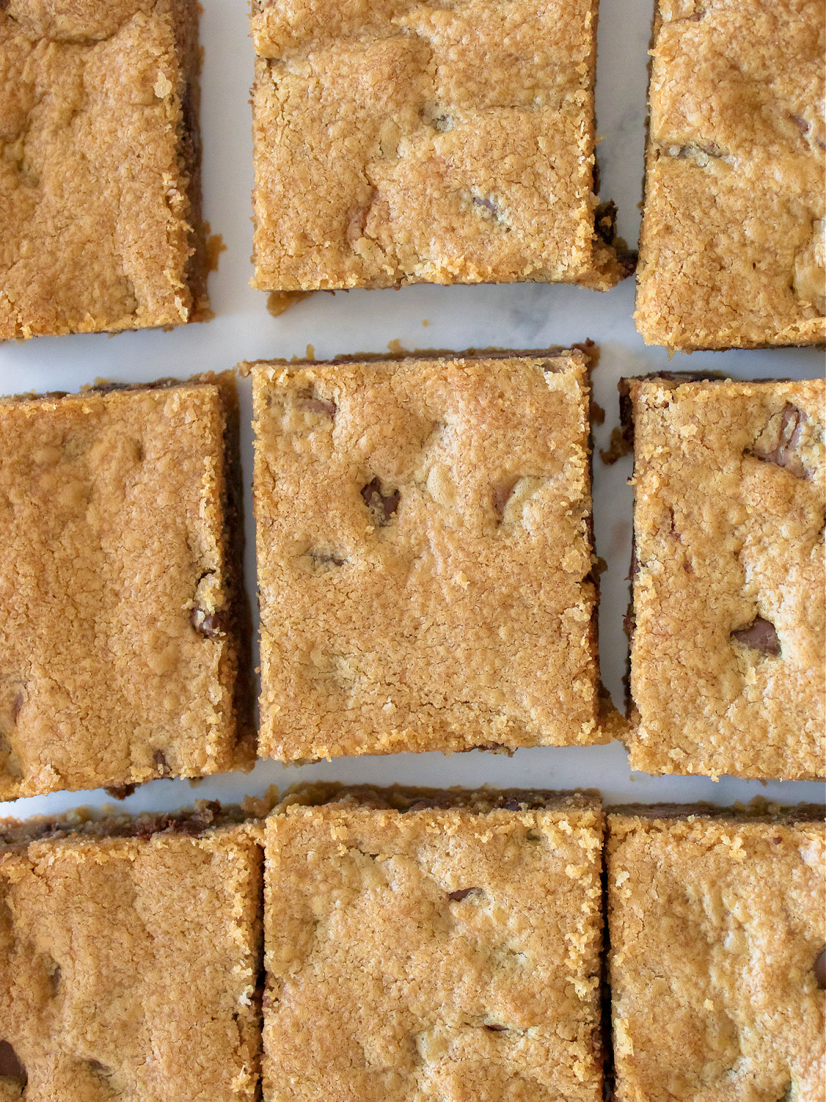 Freshly baked peanut butter blondies cut into pieces.