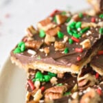Saltine crackers topped with caramel, chocolate, pecans, and sprinkles.