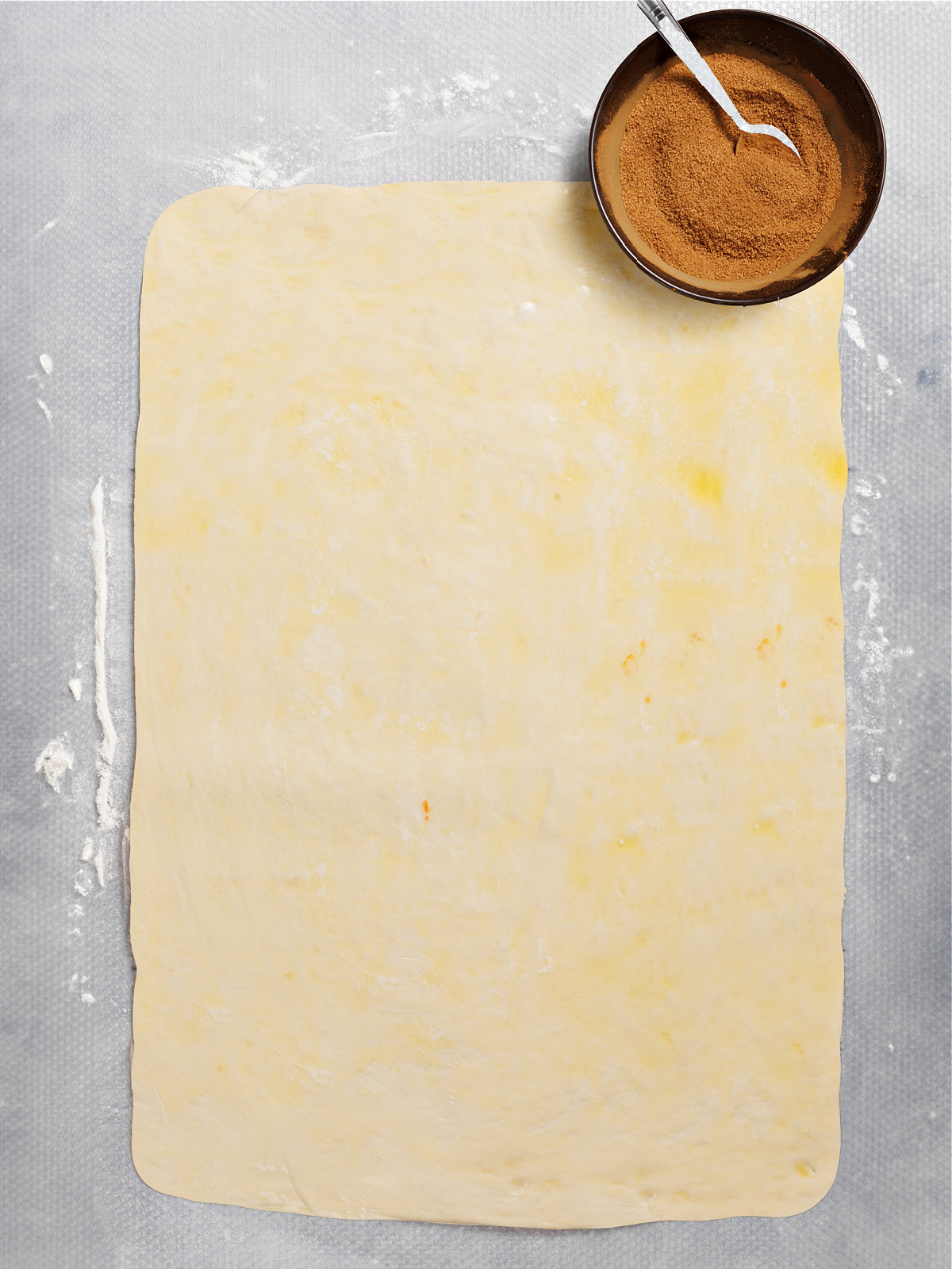 Dough rolled out into a rectangle and spread with butter.