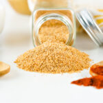 Seasoned salt spilling out of a bottle.
