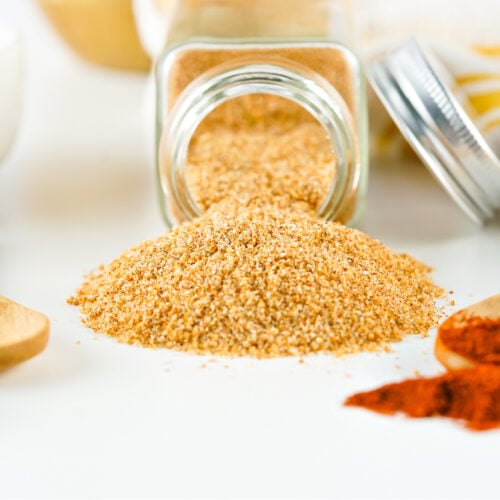 Seasoned salt spilling out of a bottle.