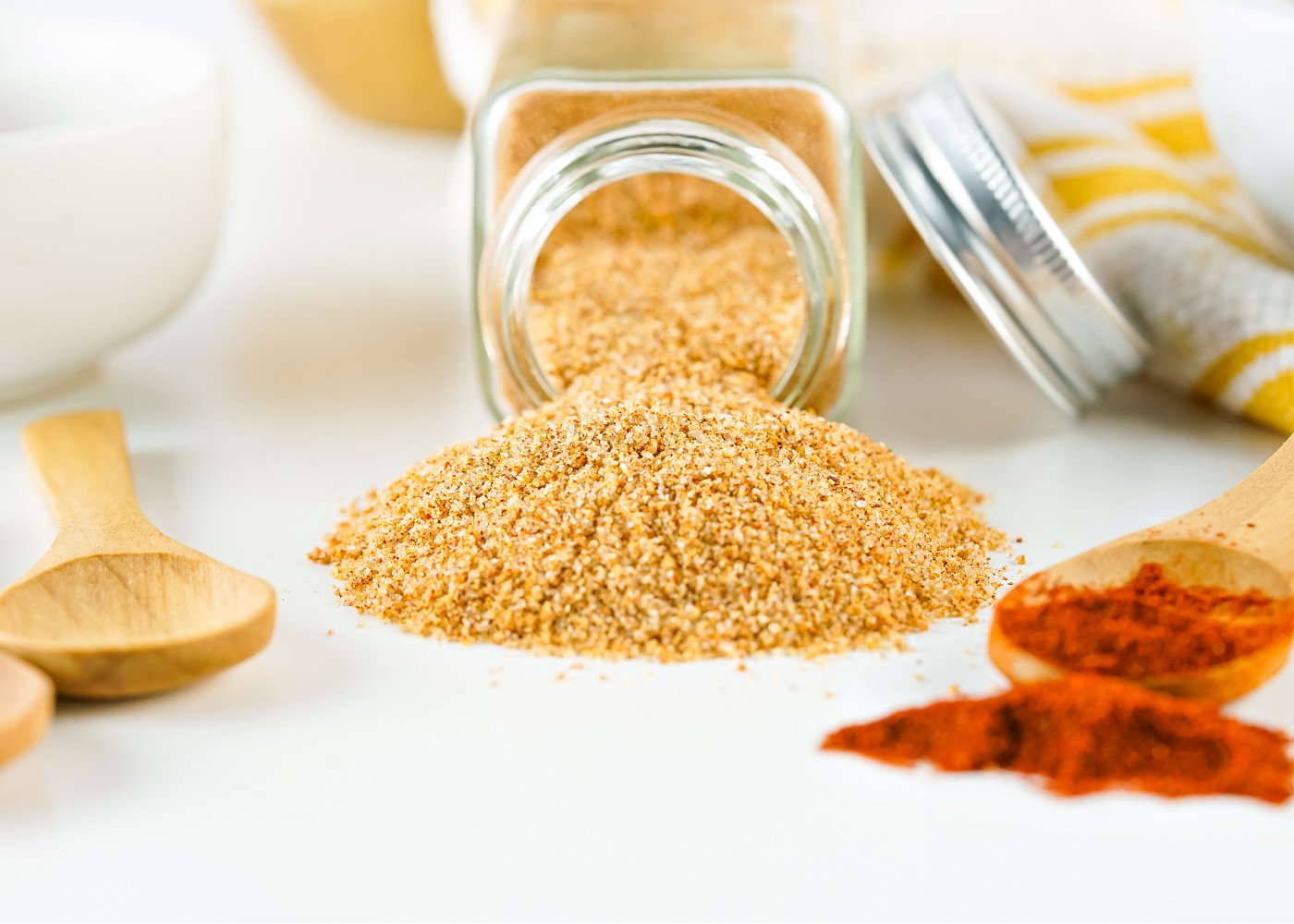 Seasoned salt spilling out of a bottle.