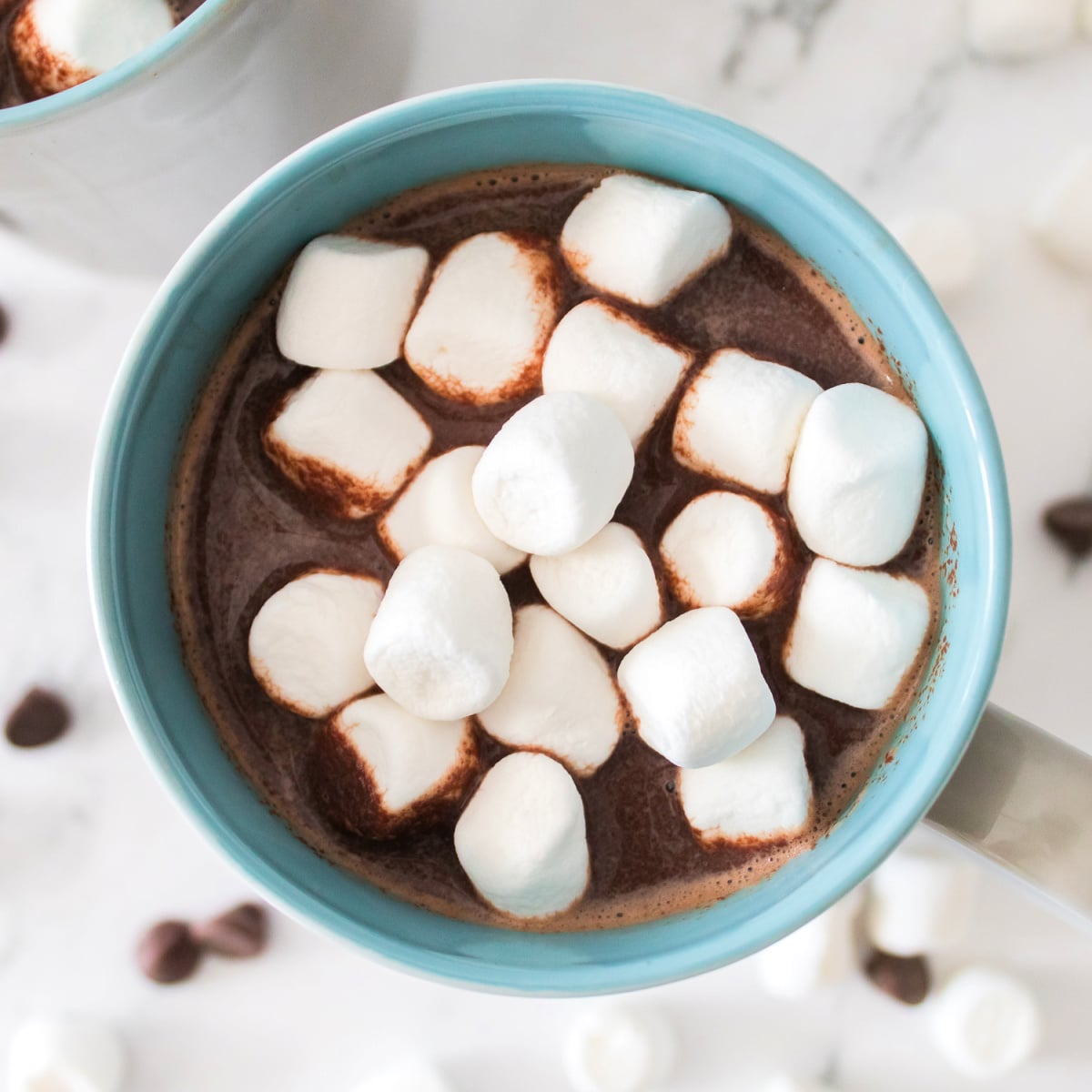 Cozy mug of homemade hot chocolate piled high with fluffy mini marshmallows.