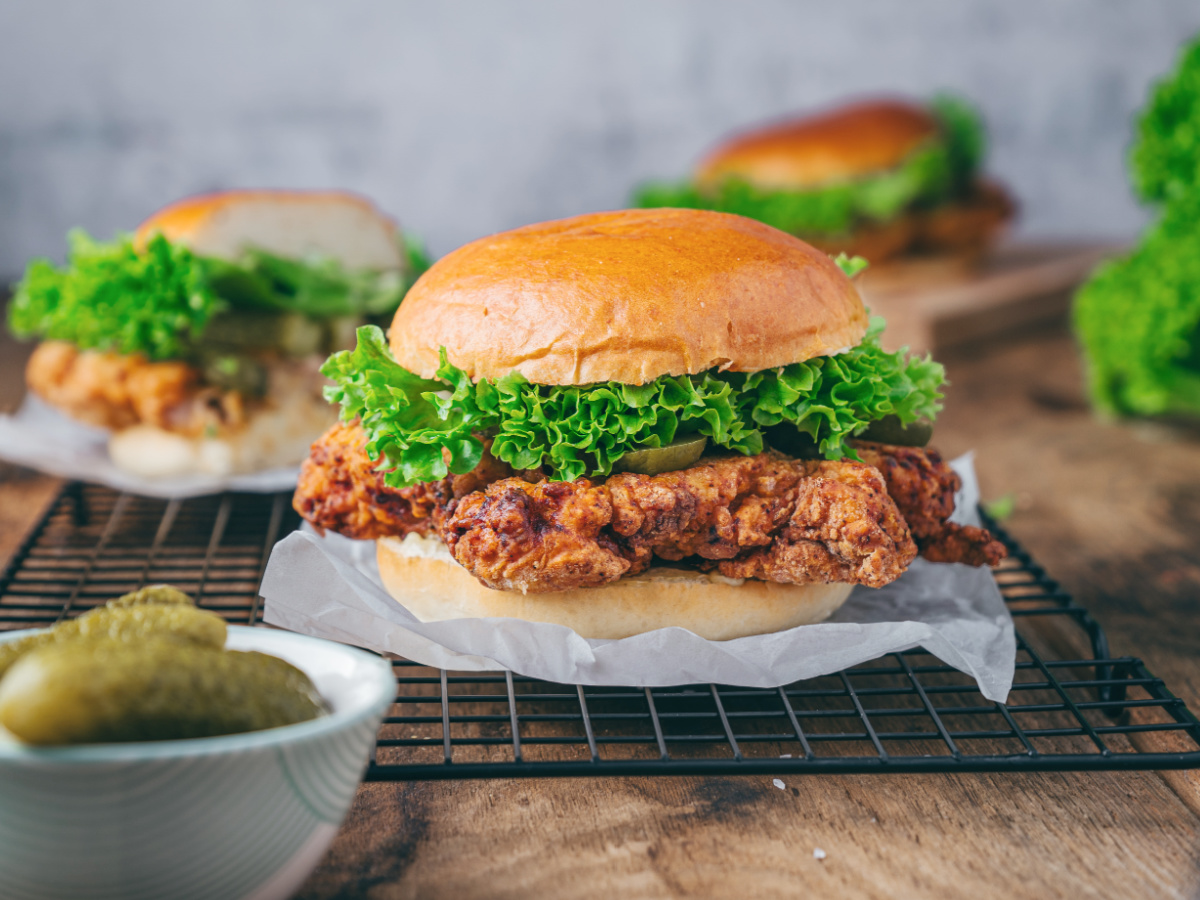 Fried chicken sandwiches on a wire rack.