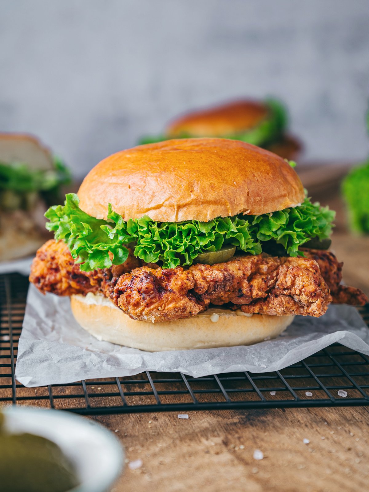 Fried chicken sandwich on a brioche hamburger bun.