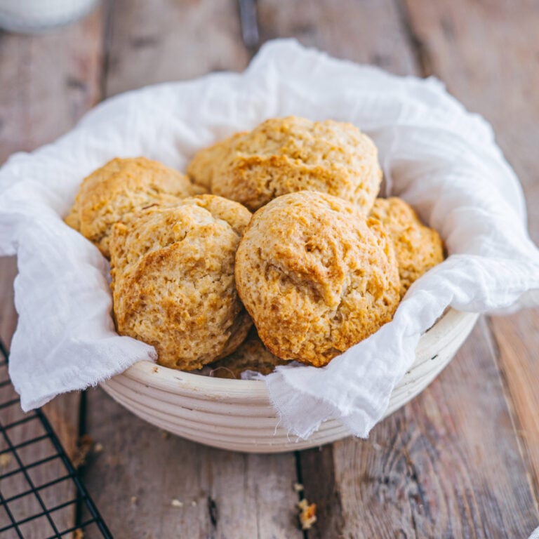 Rustic basket filled with warm, golden buttermilk drop biscuits.