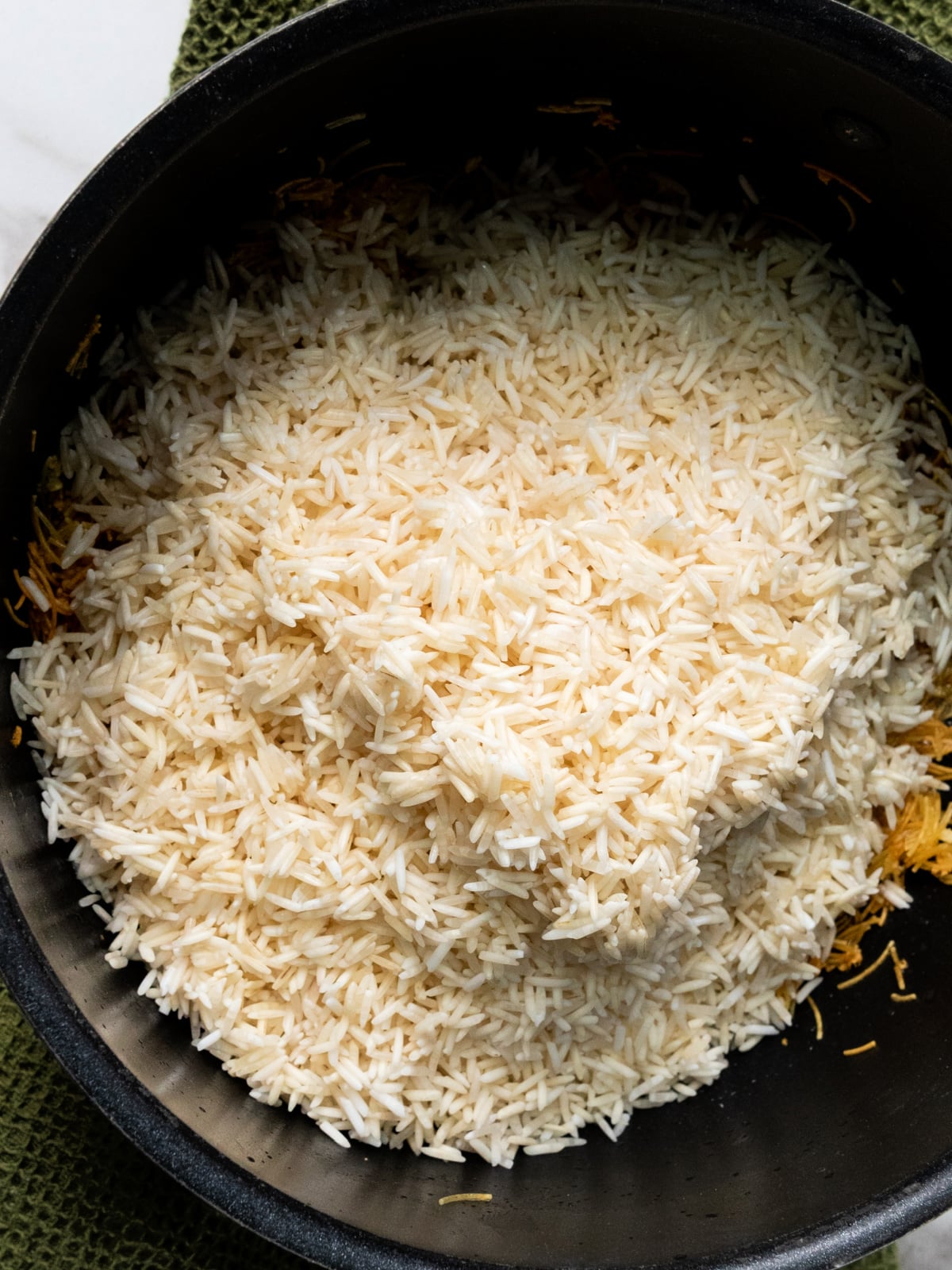 Rice added to a pot.