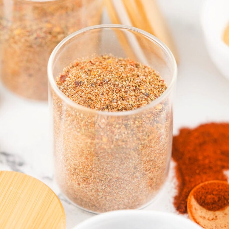 Glass jar packed with freshly mixed Jamaican jerk seasoning.