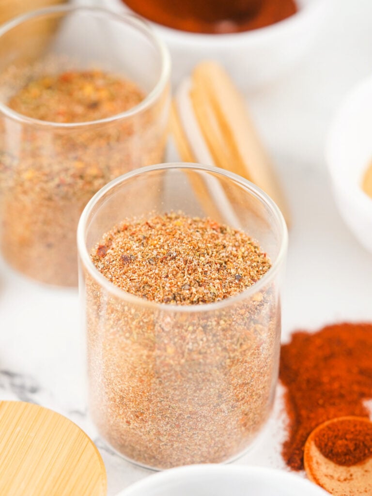 Glass jar filled with homemade Jamaican jerk seasoning blend.