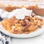 Rich, spiced slice of Pumpkin Crunch Cake highlighting the crunchy pecan layer and moist pumpkin base.
