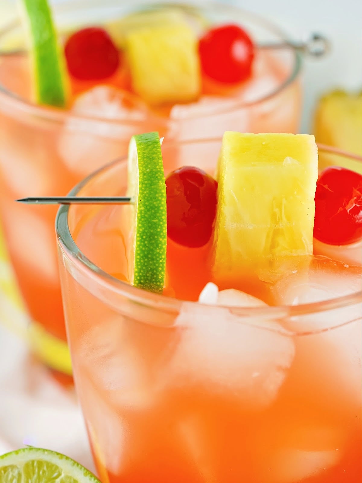 A tropical cocktail served over ice, finished with fresh fruit for a splash of color.