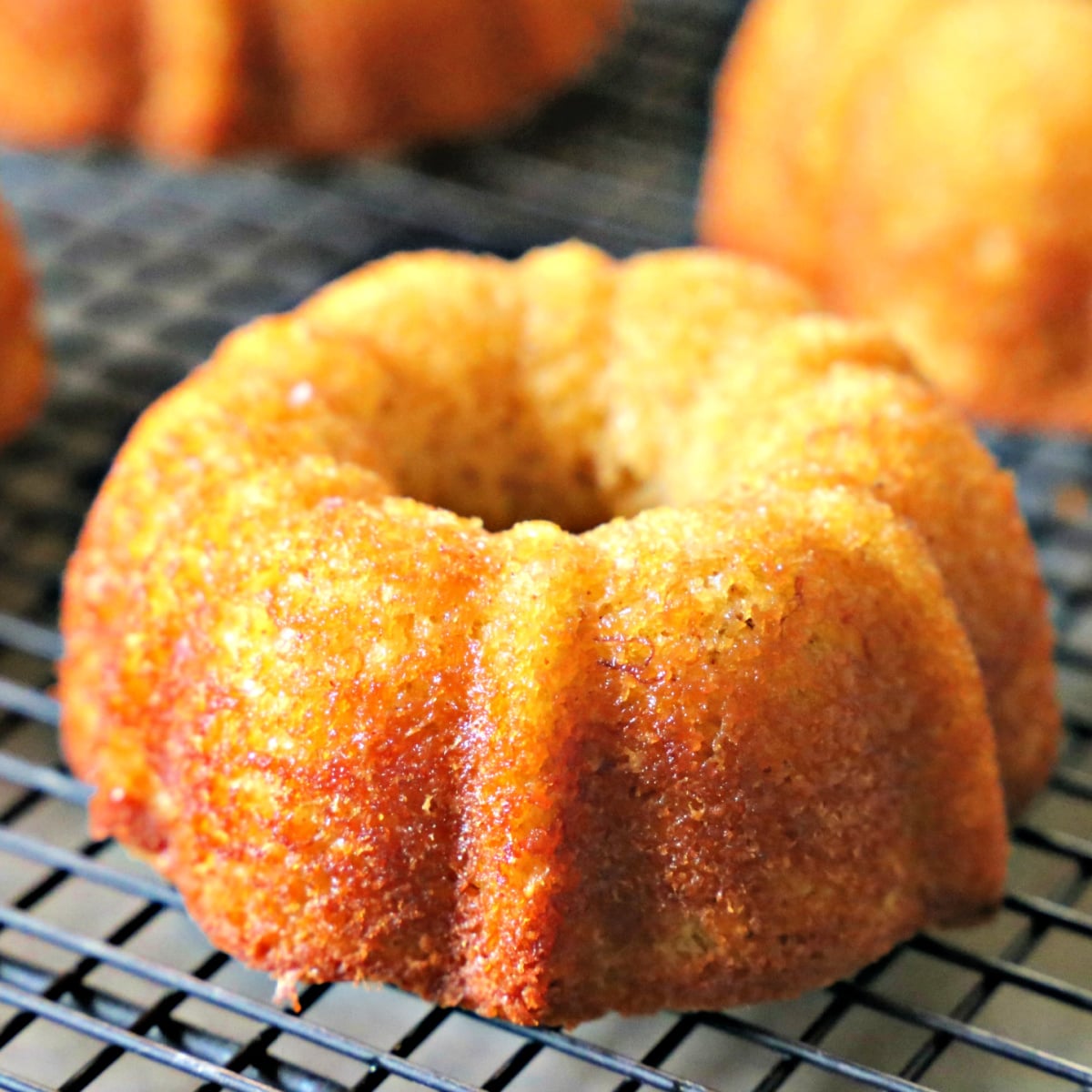 A tight shot showing the golden crumb and decorative bundt ridges of a freshly baked mini banana cake.