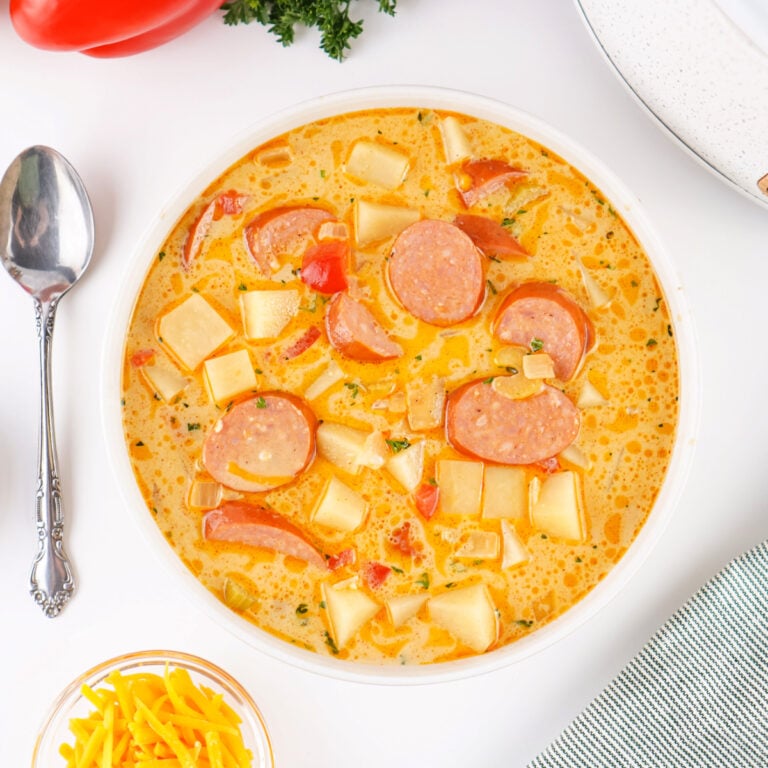 Overhead view of Cajun Potato Soup in a bowl with a spoon placed beside it.