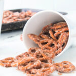 Cinnamon sugar pretzels spilling out of a white bowl after baking.