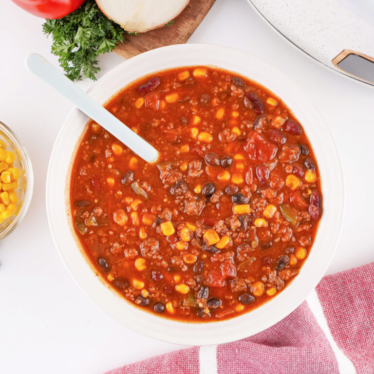 Overhead view of Cowboy Soup served in a bowl with a spoon.