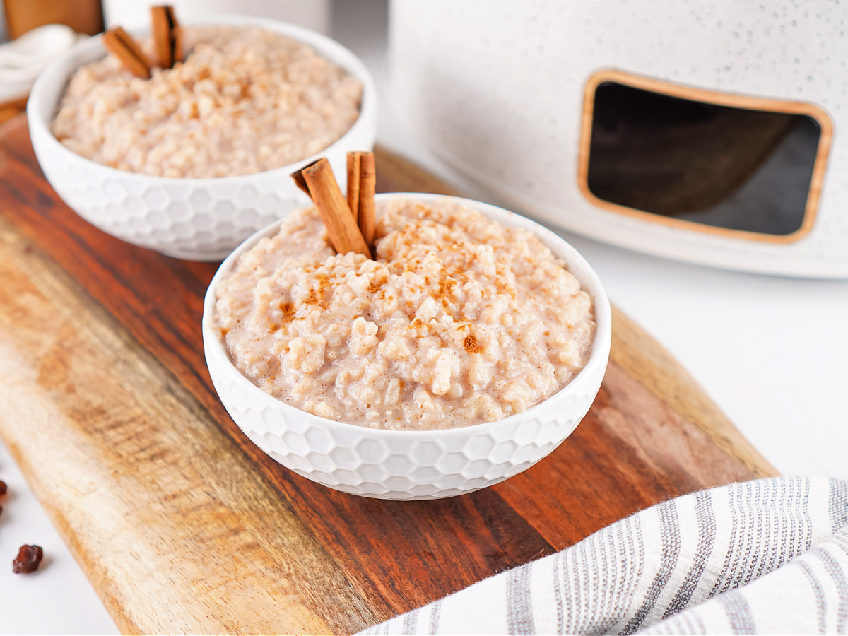 Two bowls of creamy rice pudding topped with cinnamon and ready to serve.