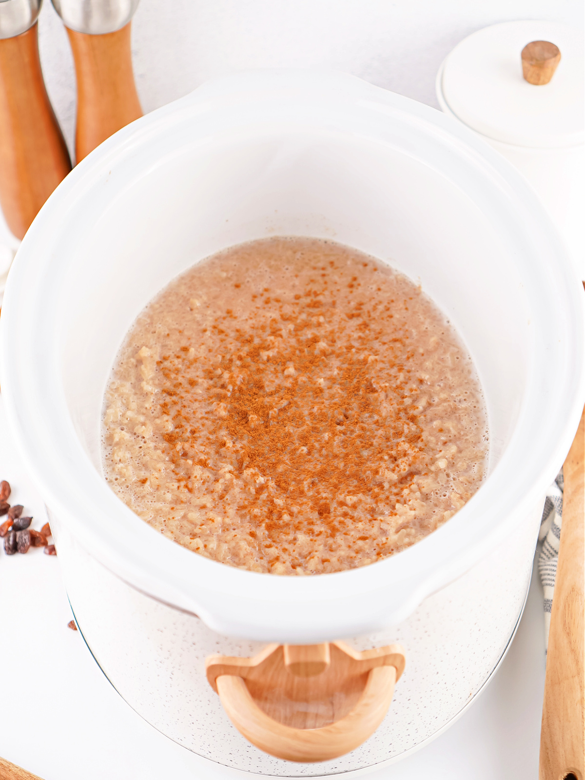 Warm Crockpot rice pudding topped with a light dusting of cinnamon.