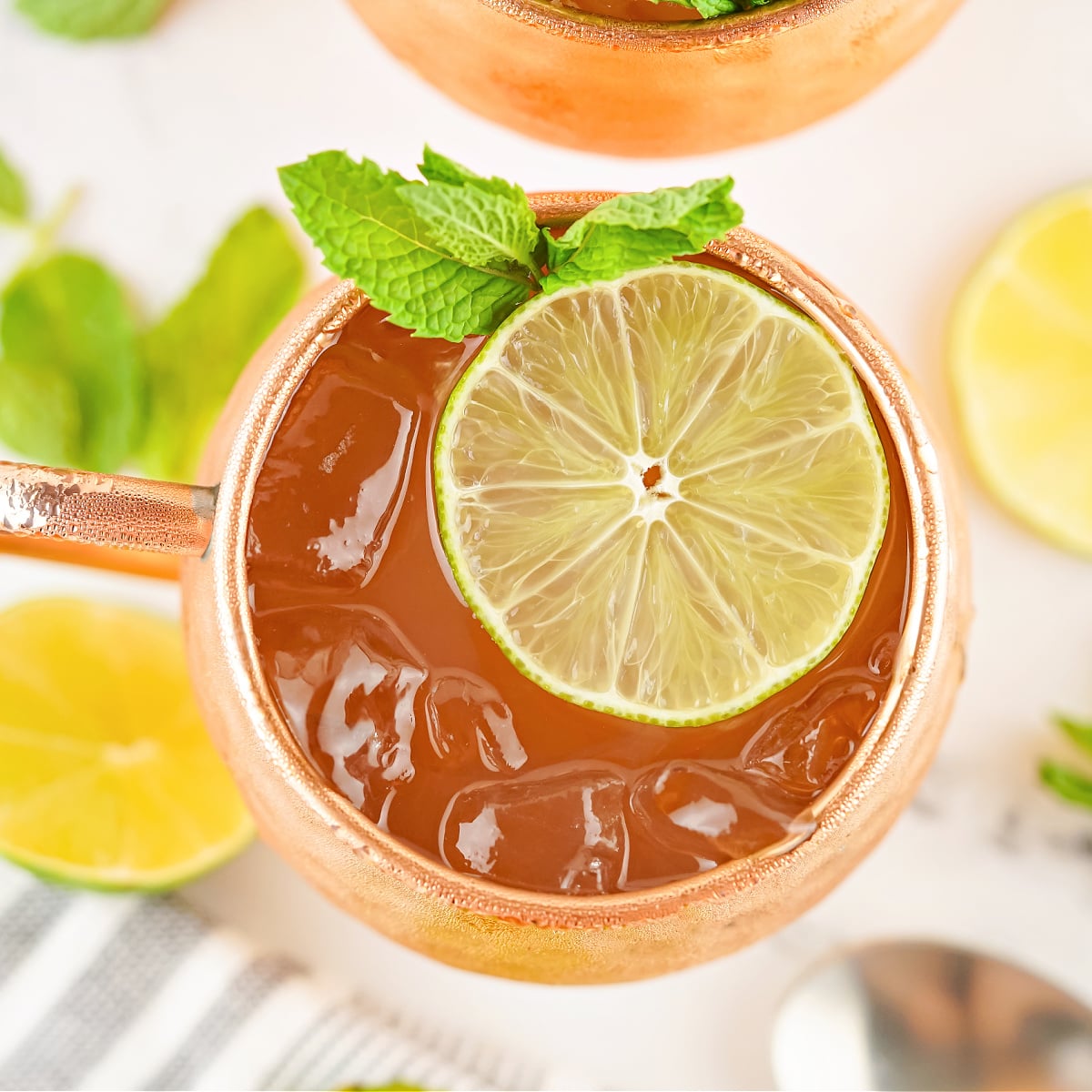 Overhead view of a copper mug filled with Moscow Mule and garnished with a lime slice.