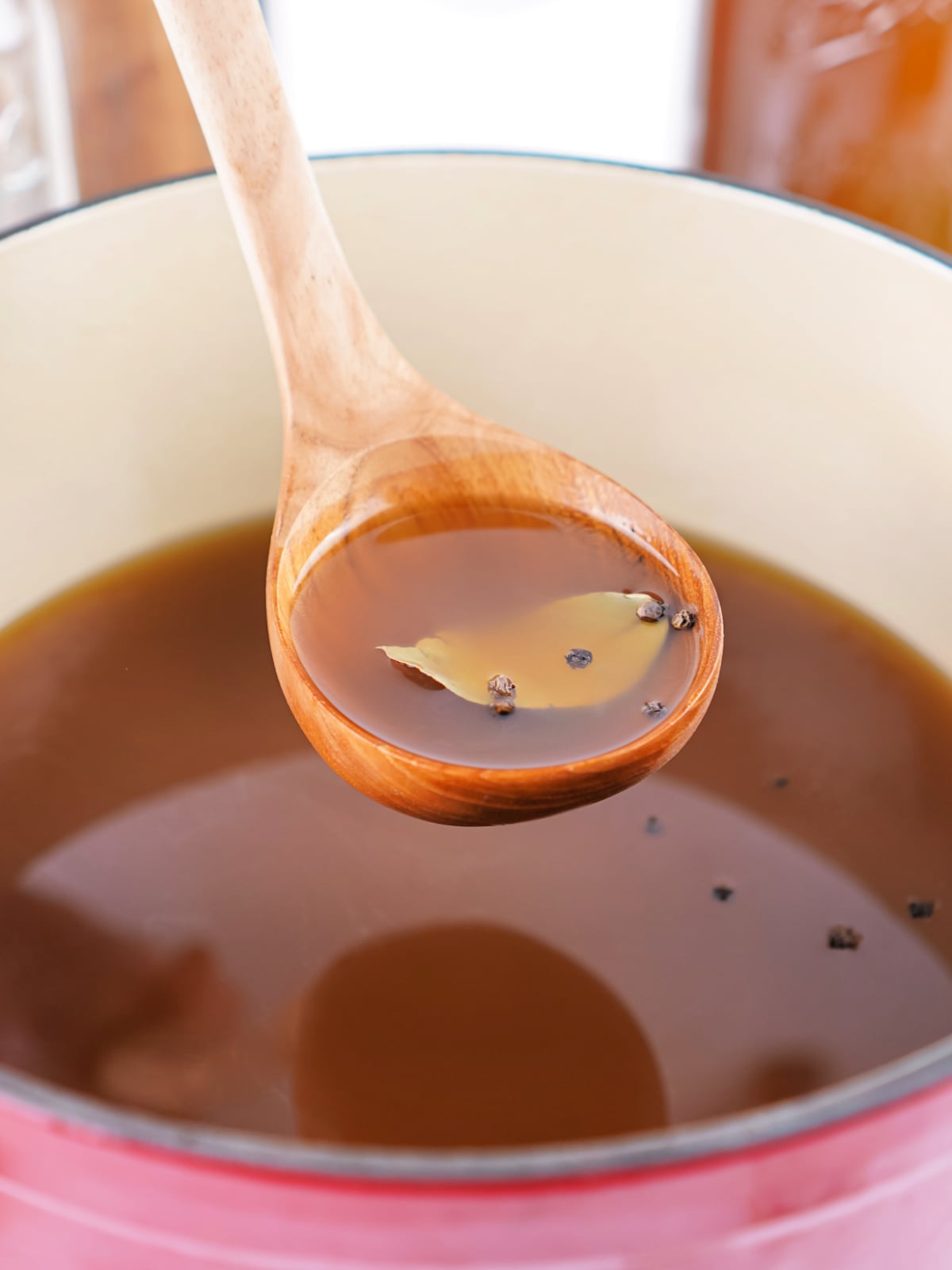 A ladle full of freshly made vegetable stock.