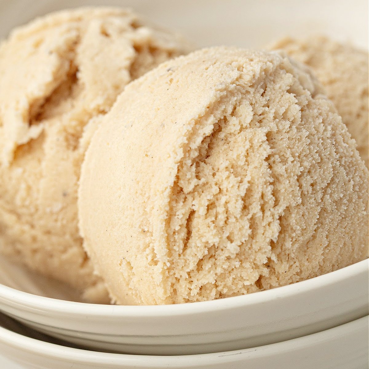 Close-up of creamy high protein vanilla ice cream with smooth scoop texture.