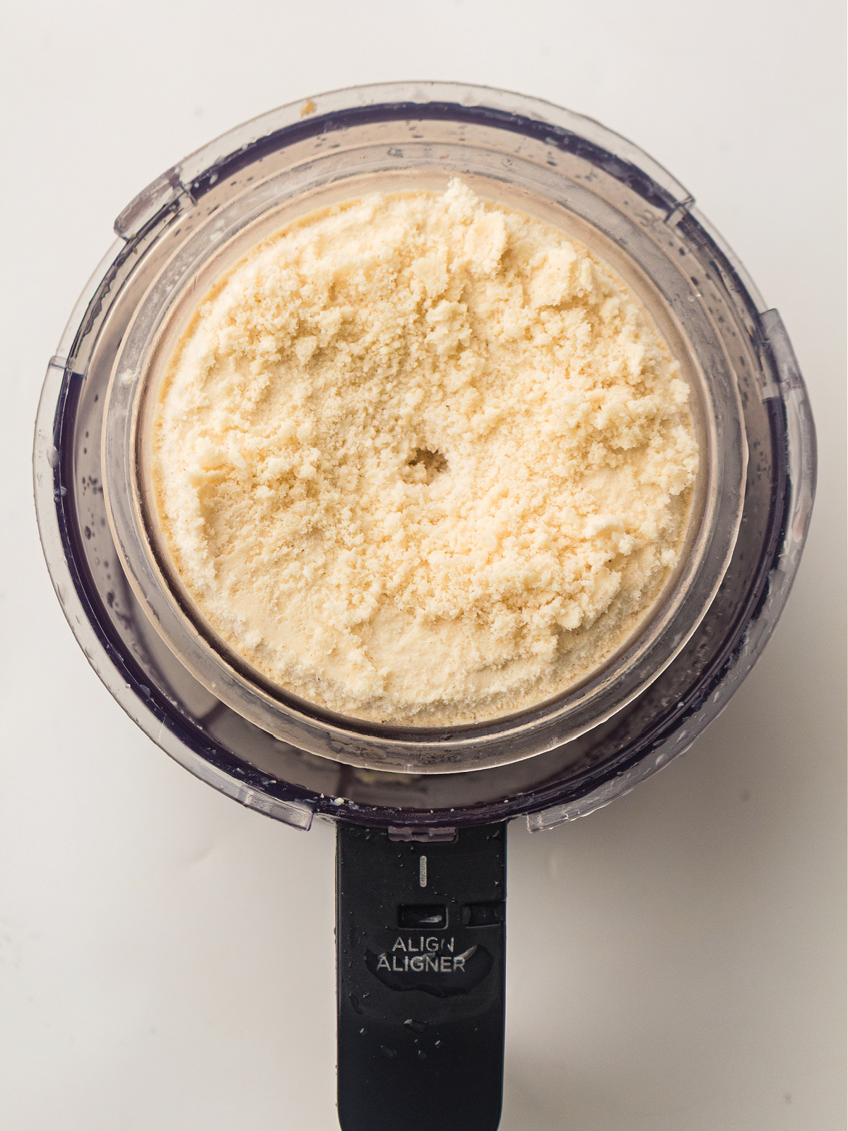 Frozen high protein ice cream base inside a Ninja Creami pint before processing for the second time.