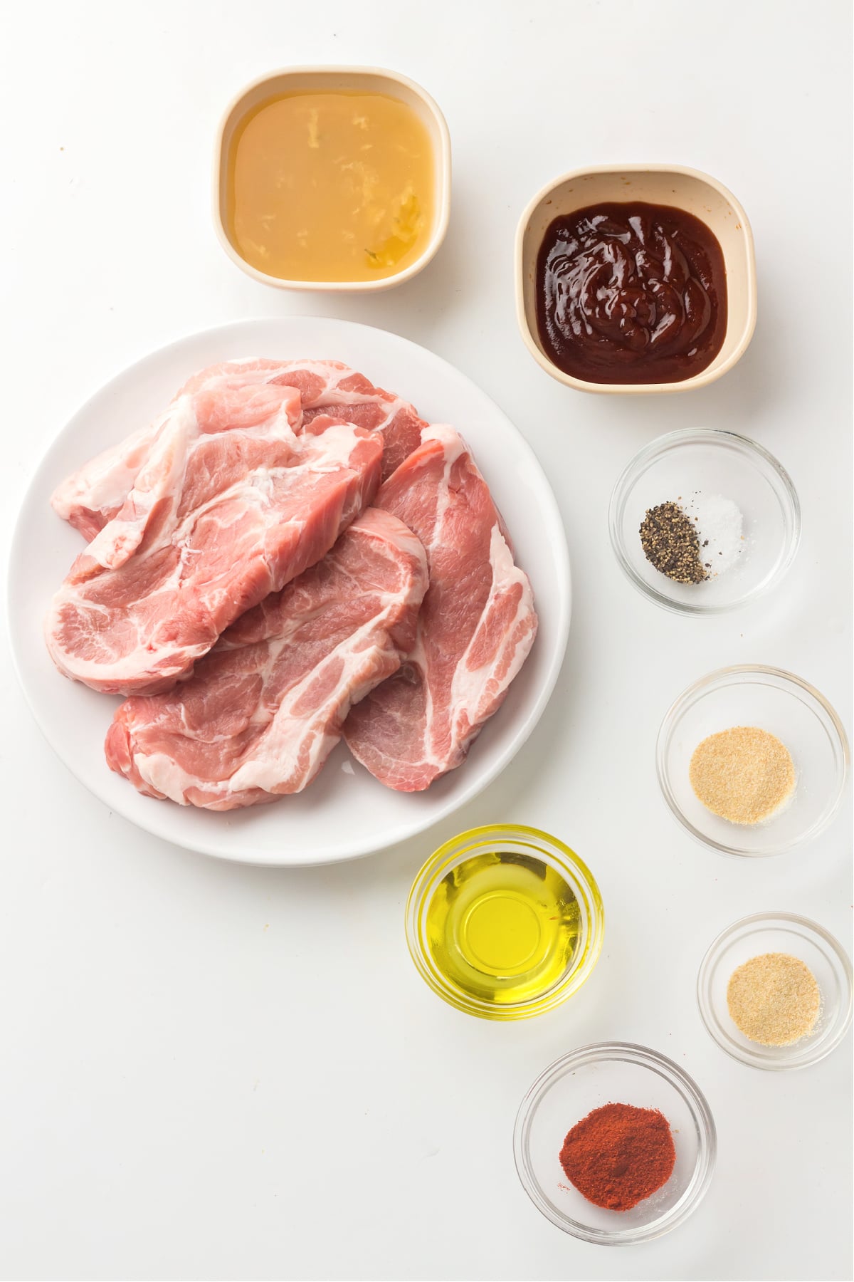 Ingredients for instant pot pulled pork arranged on a white background.