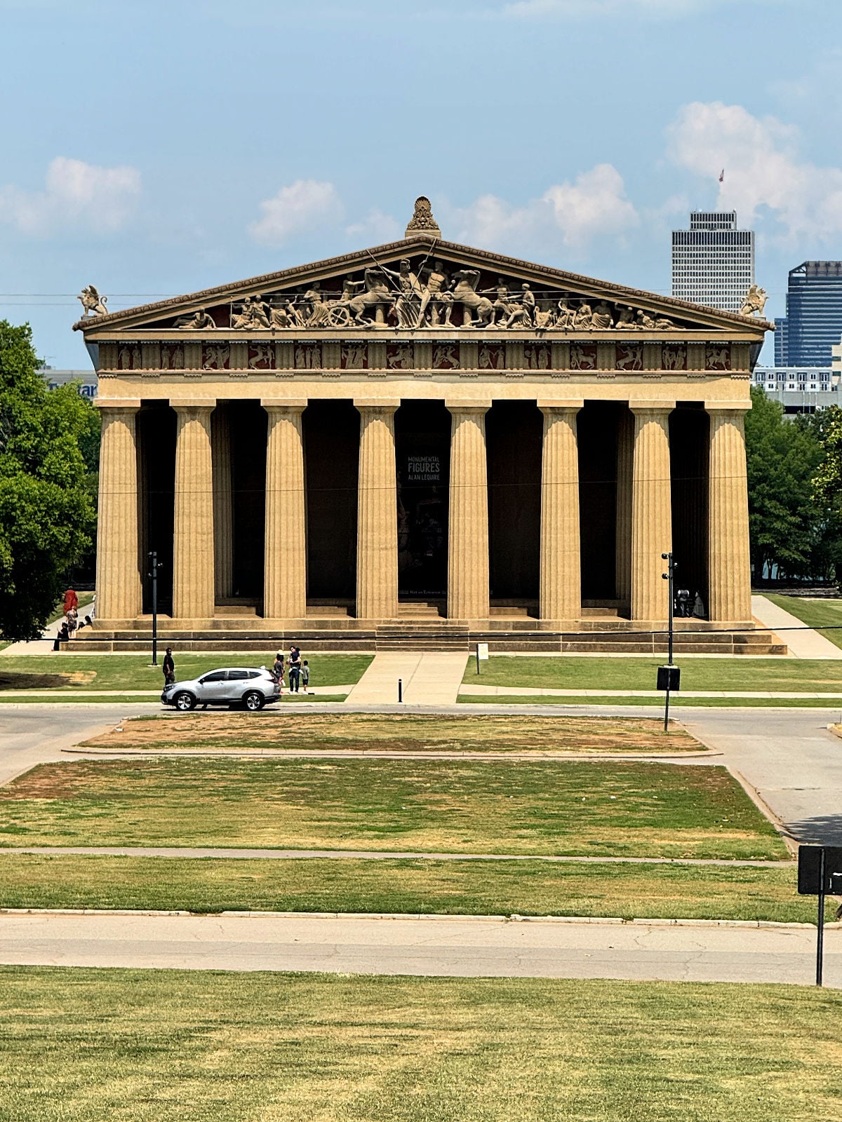 Full-scale replica of the Parthenon in Centennial Park, Nashville, with downtown skyline visible in the background.