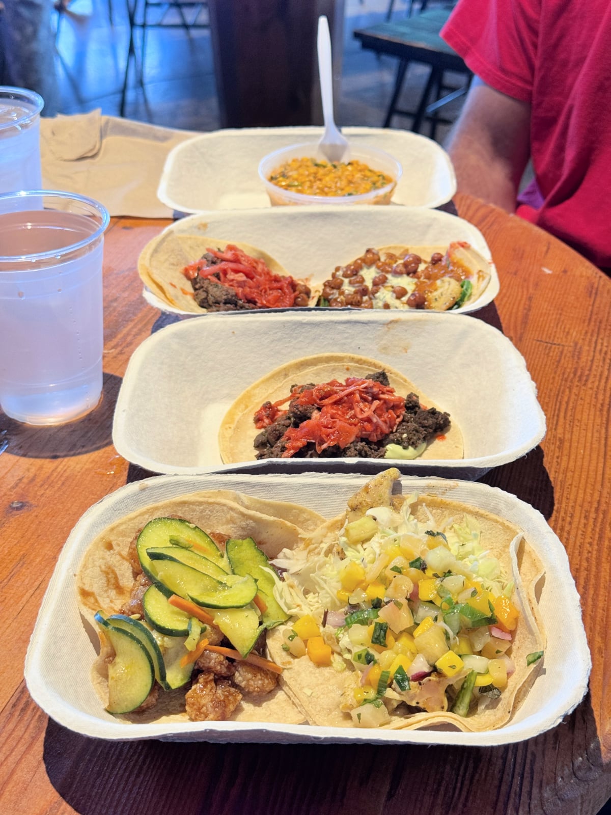 Assorted street-style tacos with fresh toppings and sides served at a Nashville restaurant.
