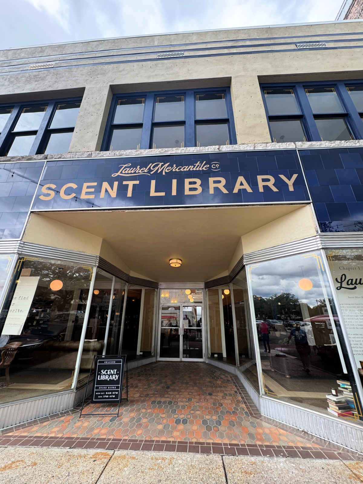 Storefront of Laurel Mercantile Co. Scent Library with navy tile façade and gold lettering in downtown Laurel.