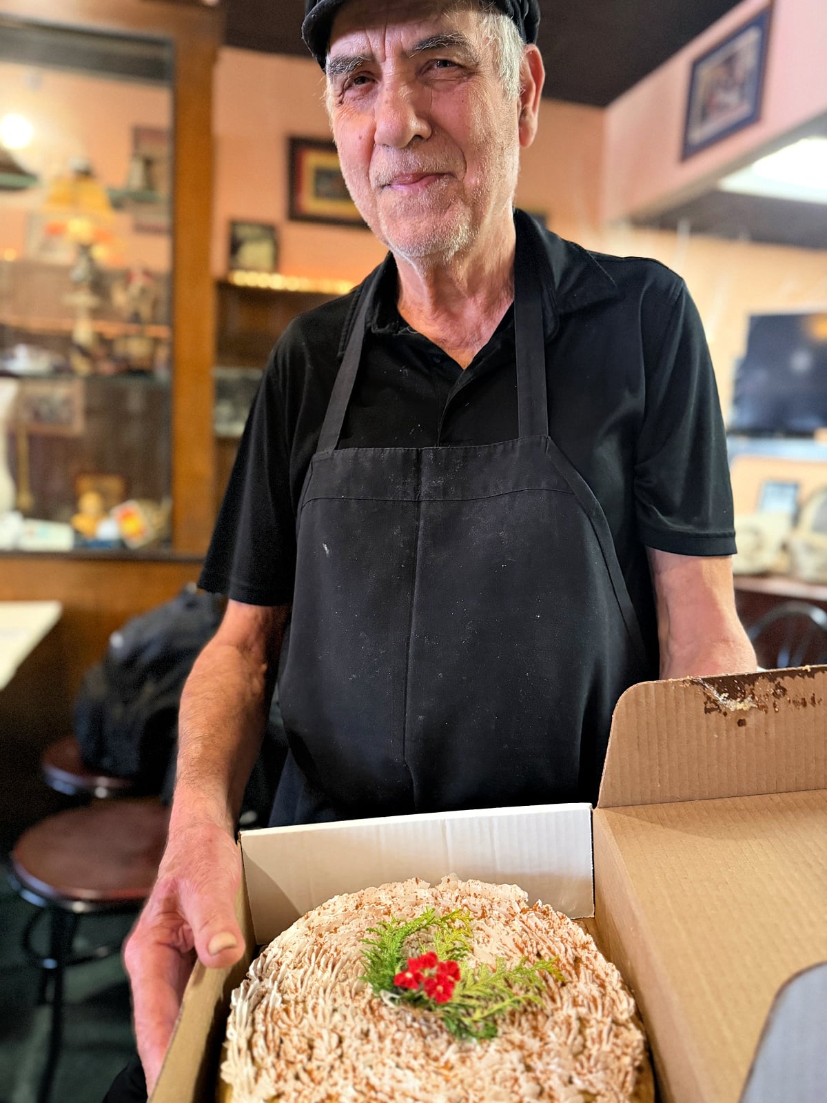 A man holding a decorated cake.