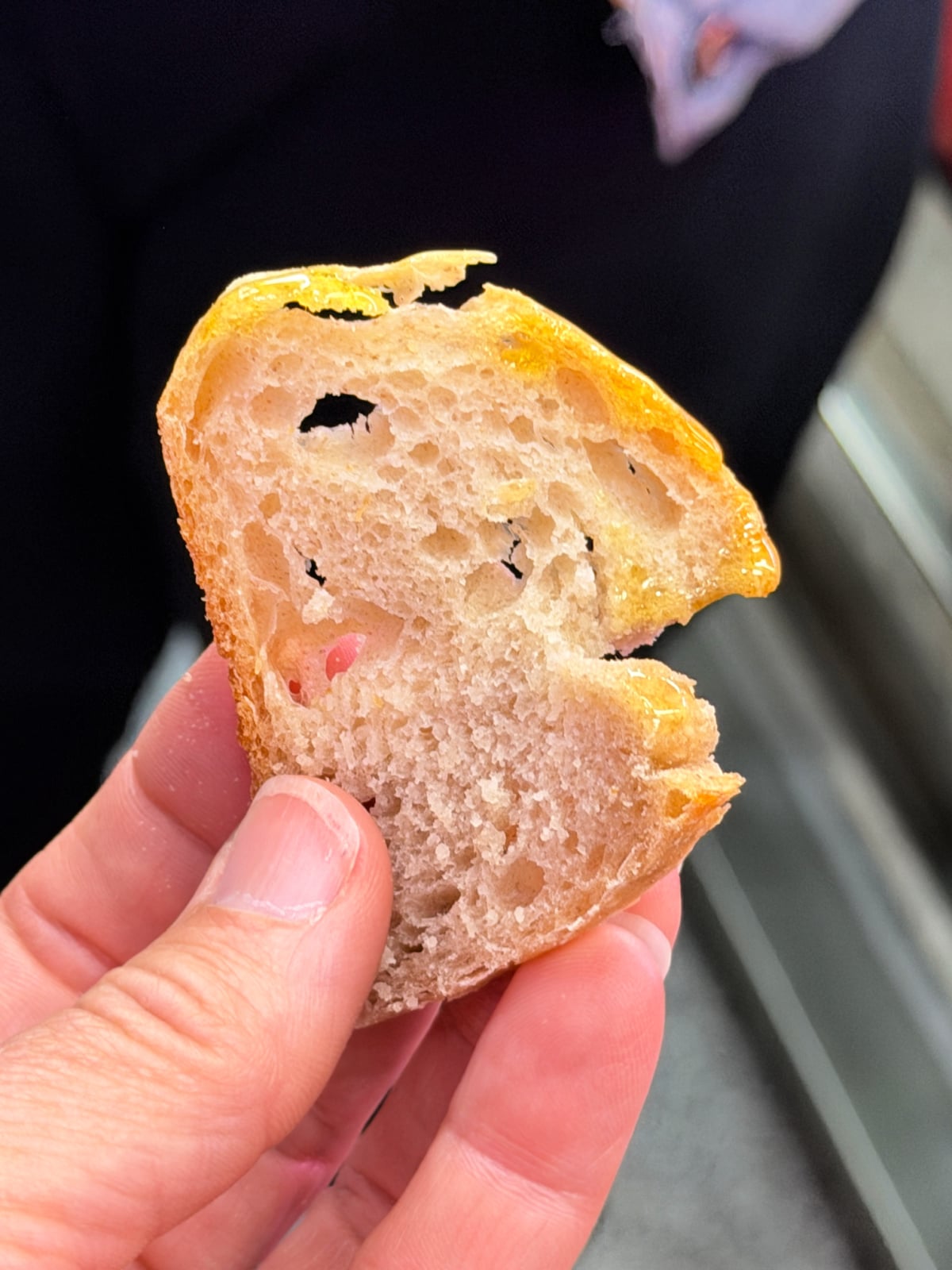 Close-up of rustic Spanish bread drizzled with olive oil.