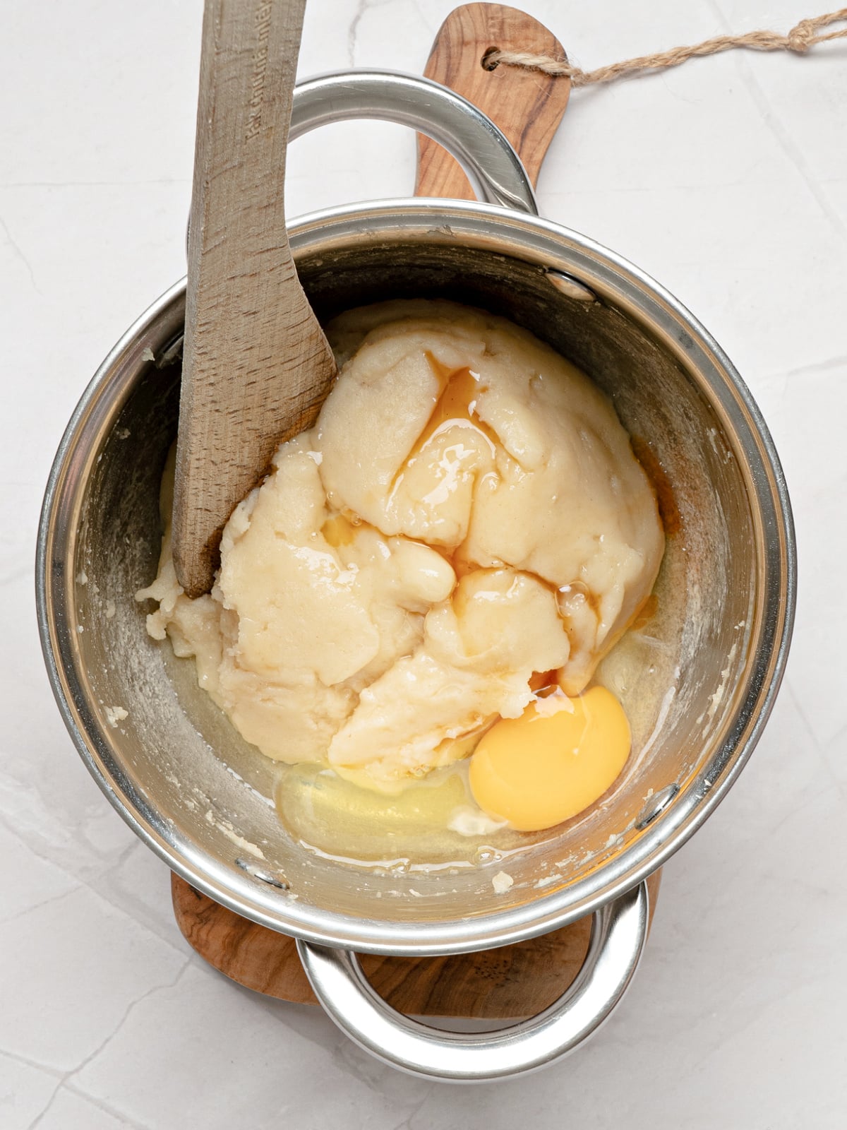 Churro dough with egg and vanilla added before stirring into a smooth, pipeable consistency.