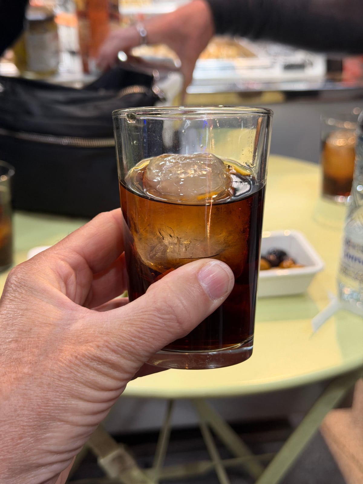 Glass of Spanish vermouth served over ice during a tapas and food tour in Madrid.