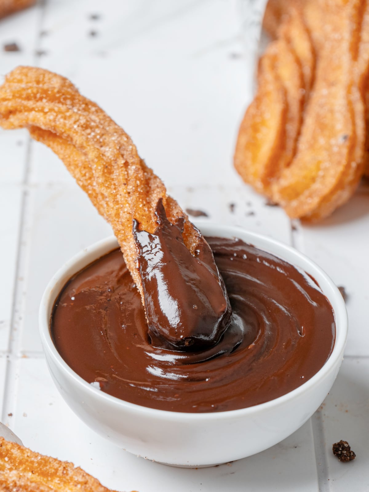 Cinnamon sugar churro dipped into thick homemade chocolate sauce.