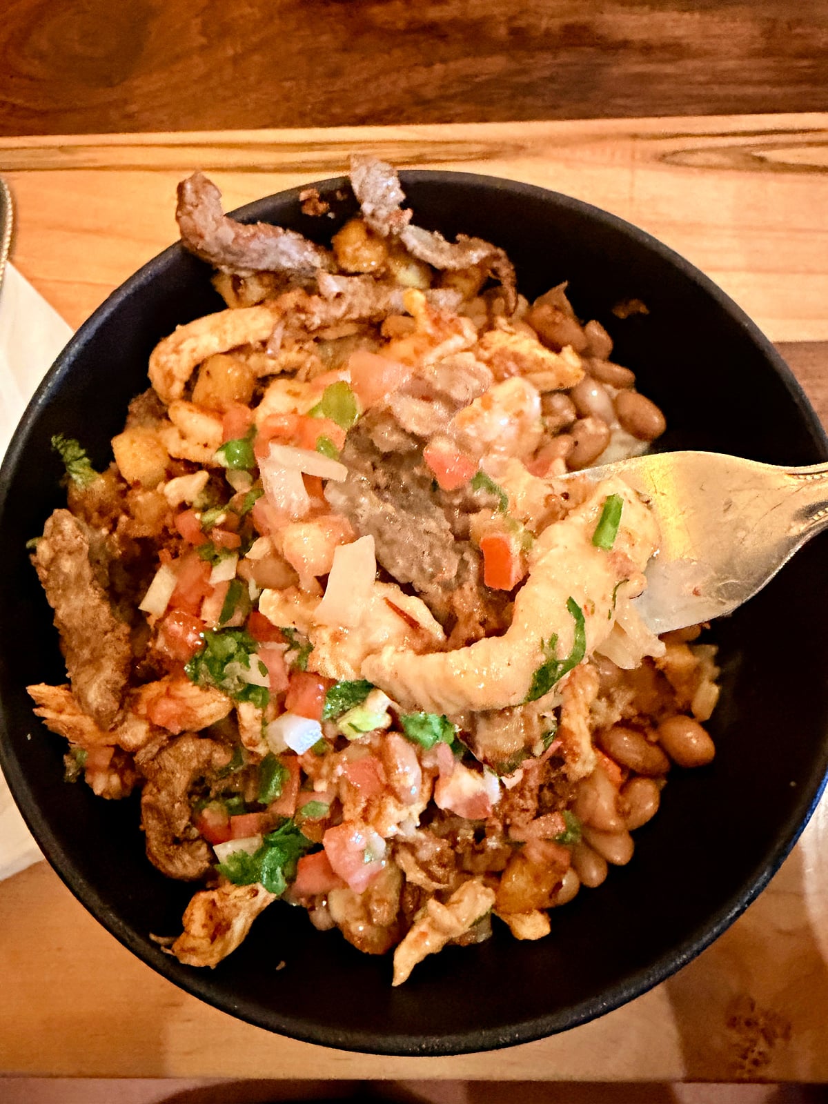 Hawaiian Bowl with grilled chicken, steak, shrimp, beans, pico de gallo, and cheese sauce.