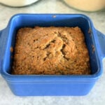 Small-batch zucchini bread baked until golden brown in a blue ceramic dish.
